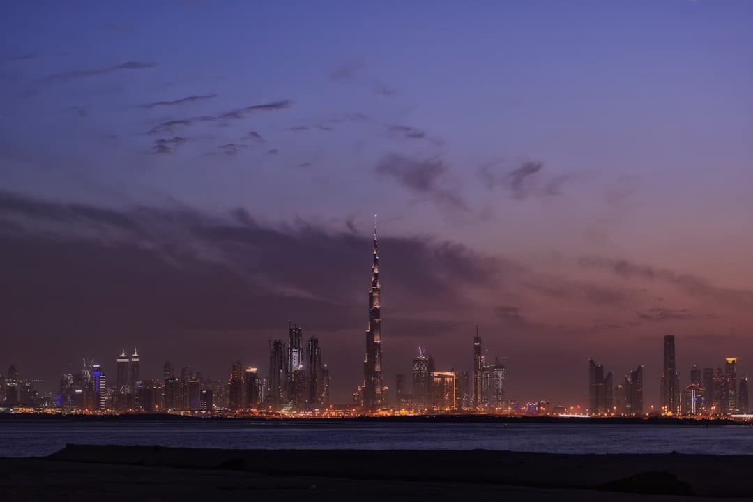 Traveler with smartphone and Dubai skyline, UAE
